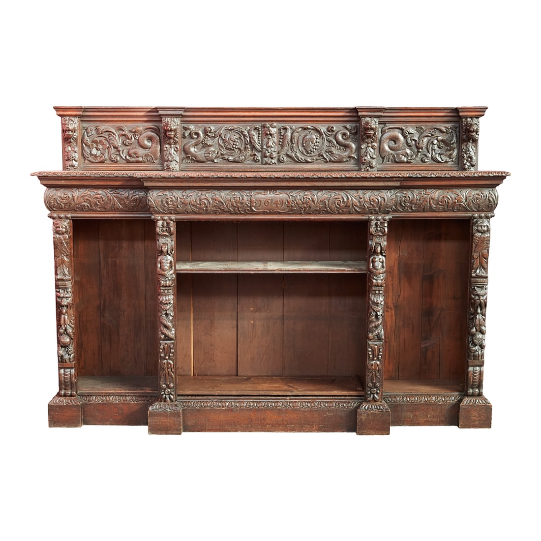 Italian Renaissance Revival Oak Bookcase: Italian Renaissance Revival Oak Bookcase, back crest over stepped design, carved with dolphins, dog and lion head masks, scrolling foliage and flowerheads, and the front pilasters carved with griffins