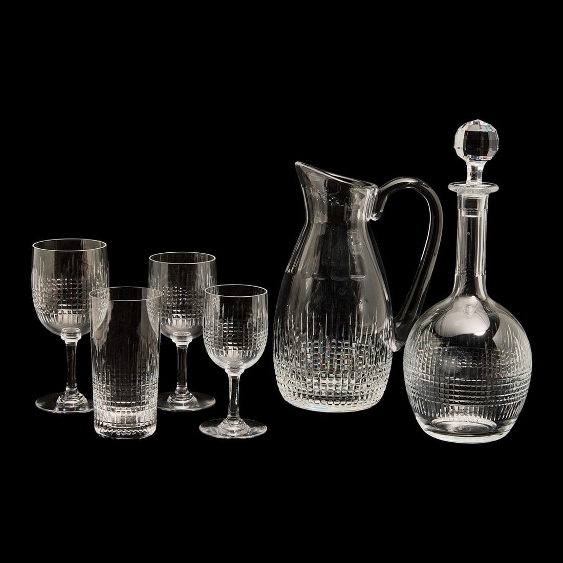 Set of Baccarat Nancy Crystal Glassware: Forty Two Piece Set of Baccarat Nancy Crystal Glassware. Comprising carafe with stopper, pitcher, ten water glasses, ten small wine goblets, ten medium wine goblets, and ten larger wine goblets. Circu