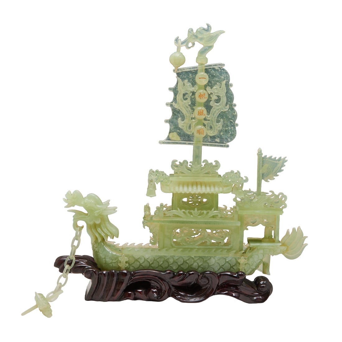 A Chinese Carved Jade Dragon Boat on Stand: A Chinese carved jade dragon boat sculpture displayed on a fitted wooden stand, carved from pale green to celadon-toned jade with natural stone variation. The boat is worked in layered openwork relief