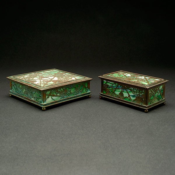 Pair of Tiffany Studios Grapevine Desk Set Boxes: Pair of Tiffany Studios Grapevine Desk Set Boxes. Each bronze box is backed with green Favrile glass with white streaks and finished in a green and brown patina on the grapevine filigree. Both boxes i
