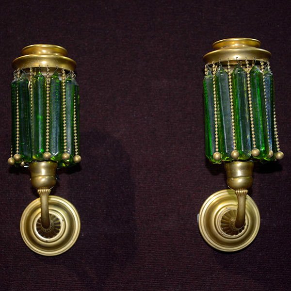 Pair of Tiffany Studios Prism Sconces.: Pair of Tiffany Studios Prism Sconces. The matching pair of sconces each featuring eleven green glass prisms and ball chains with original gold finish. Unsigned. Extra prisms are included with this lo