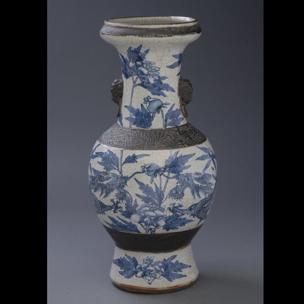 A Blue and White Crackle Ware Vase: A Blue and White Crackle Ware Baluster Vase, decorated with two dragons and flowers, faux mask and ring handles {Height: 17 3/4 inches (45 cm)}