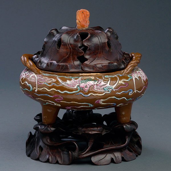 A Molded Famille Rose Censer: A Molded Famille Rose Censer, decorated with bats and swirling clouds to a brown ground, accompanied by a reticulated wood stand and lid with a Buddha's hand finial {Height: 7 3/4 inches (19.7 cm) inc
