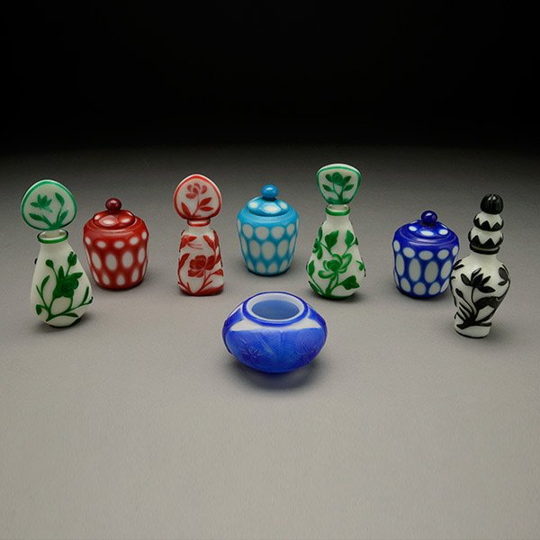 A Group of Eight Overlay-Decorated Glass Bottles: A Large Group of Eight Overlay-Decorated Glass Bottles, including four perfume bottles with stoppers, three small covered jars and one compressed washer {Tallest: 5 1/2 inches (14 cm)} [Chips; stopper