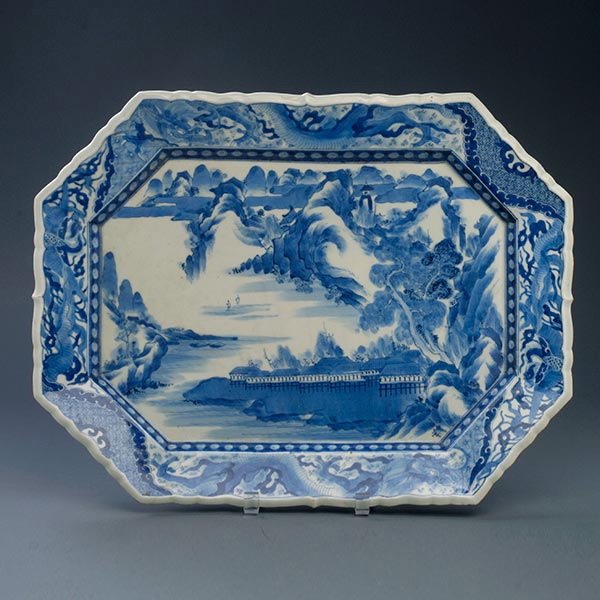 A Large Japanese Blue and White Platter: A Large Japanese Blue and White Platter, depicting a mountainous river landscape {Width: 19 3/4 inches (50.2 cm)}