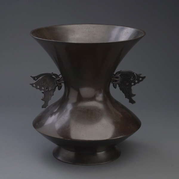 A Japanese Bronze Vase: A Japanese Bronze Vase, with butterfly form handles and an inscription to the base {Height: 12 1/4 inches (31.1 cm)} [Dents, nicks and abrasions]