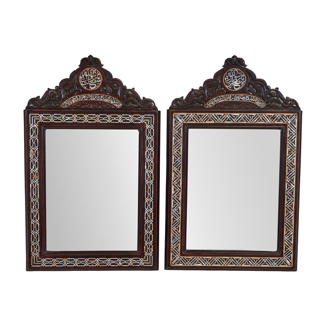 Pair of Portuguese Moorish Style Inlaid Mirrors: Pair of Portuguese Moorish Style Inlaid Mirrors, inscribed, and with elaborate carved crests. Crests and frames with bone inlay. {Approximate dimensions: 26 1/2" H. x 17 3/8" W.}.