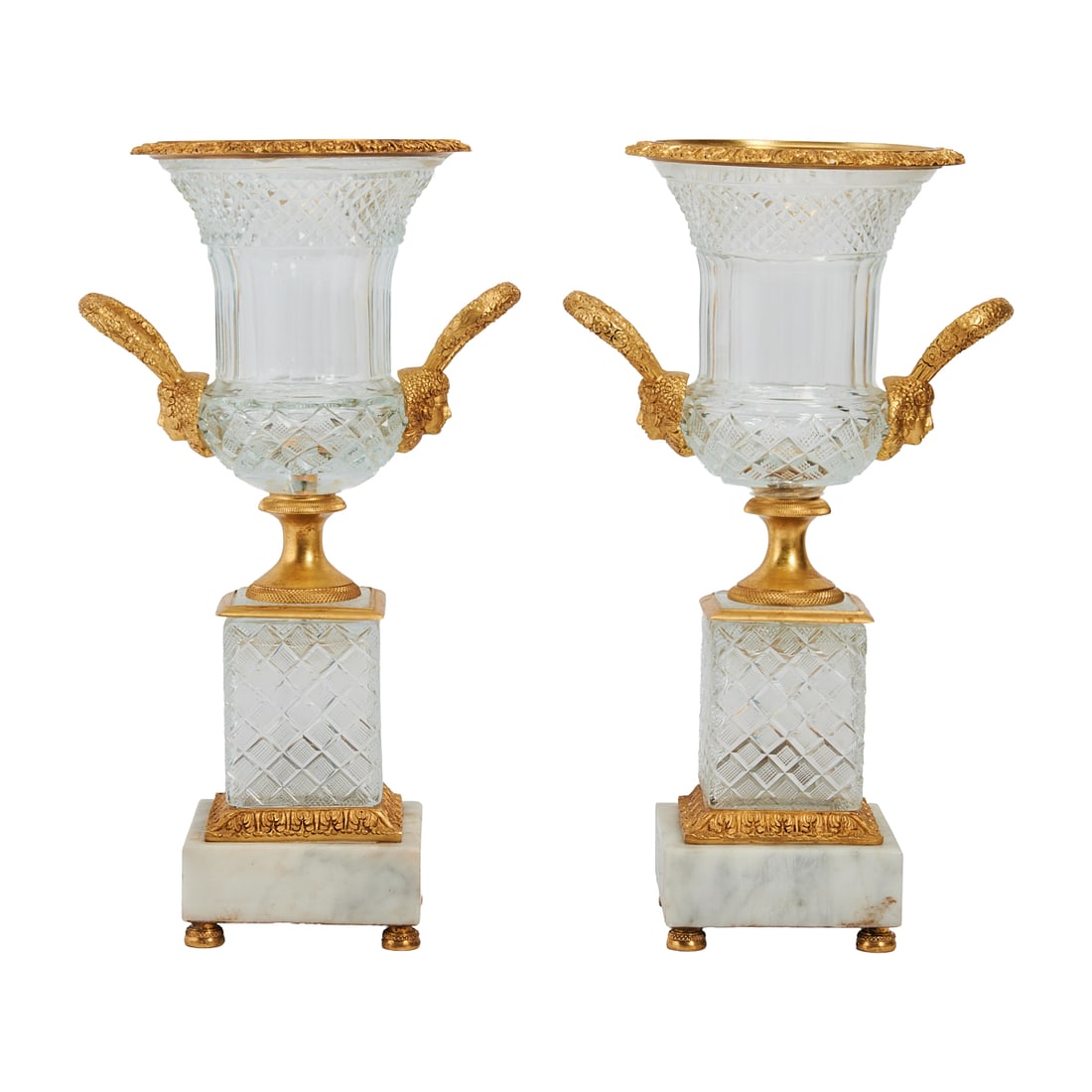 Pair of Baccarat Style Cut Crystal Urns with Bronze Mounts: Pair of Baccarat Style Cut Crystal Urns with Bronze Mounts, the urns cut in neoclassical style with flaring mouths over panels sides with multi facetted cuts, on diamond cut rectangular bases, the who