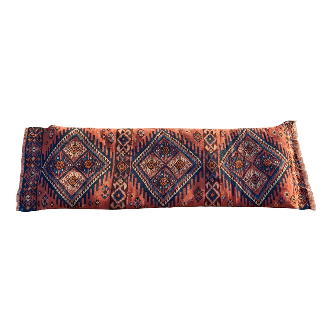 Kurdish Flat Woven Kilim Long Cushion: Kurdish Flat Woven Kilim Long Cushion, formerly a rug, woven in shades of brown, red, black and white, with six guls, the whole now folded into half lengthwise and with slender mattress like stuffing.