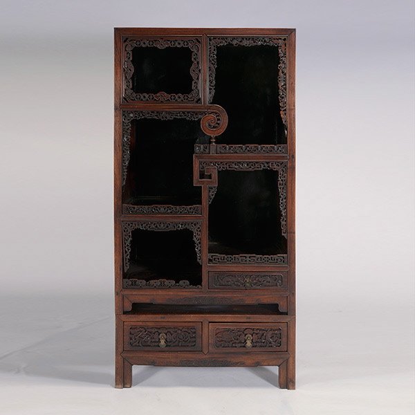 A Carved Hardwood Display Cabinet, 19th C.: A Carved Hardwood Display Cabinet, With square corner posts enclosing alternating tiered shelves, further framed by elaborately carved openwork scrolls incorporating stylized bats, butterflies, prunus