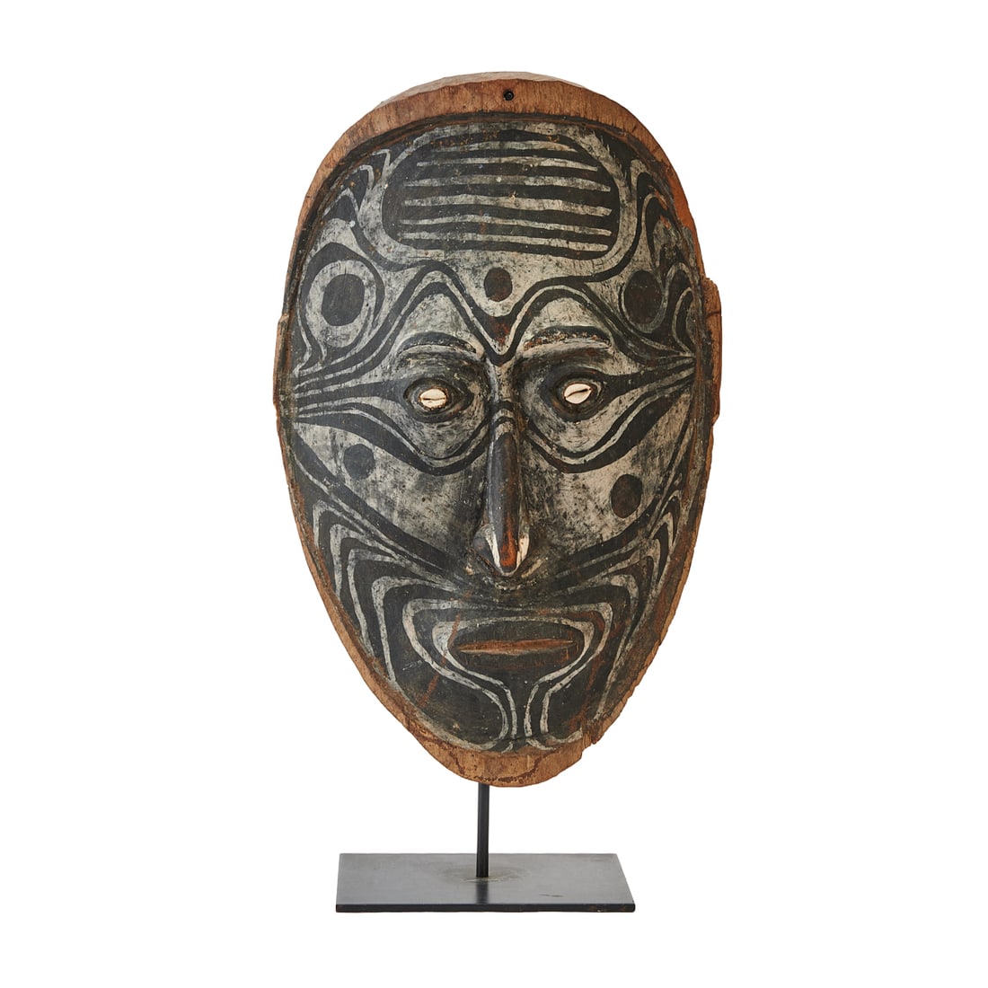 Iewa People Papua New Guinea Mask on Stand: Papua New Guinea,Mask on Stand, Inyai Ewa Sepik River, made of wood, cowrie shell eyes, on black stand{Approximate dimensions, mask: 26" H. x 17" W. x 5 1/4" D., the stand base 1/4" H. x 9" W. x 7"