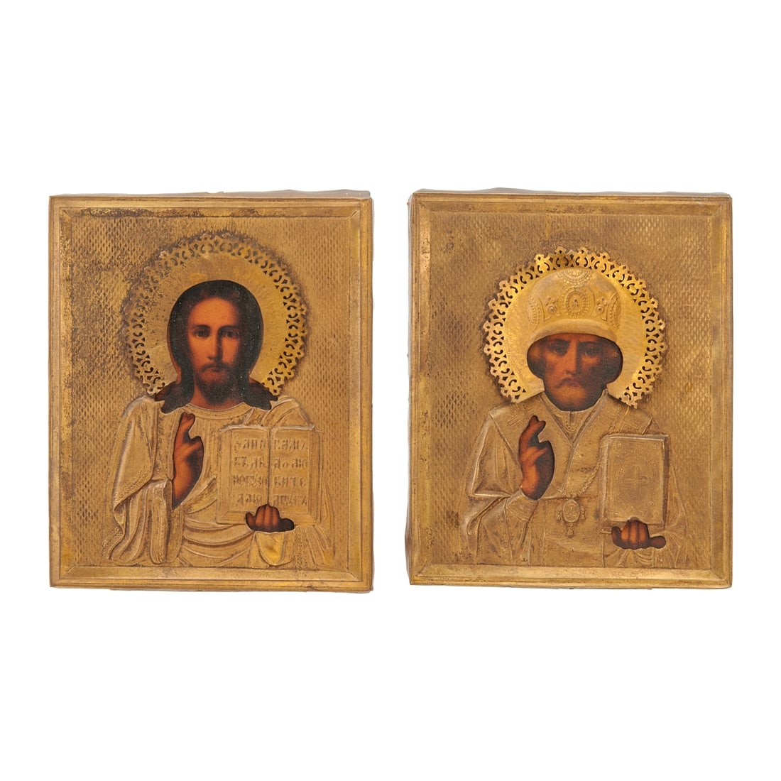 Two Russian Orthodox Oklad Icons, Christ and St. Nicholas: Two Russian Orthodox Oklad Icons, Christ and St. Nicholas, painted in polychrome enamels, and with gilt metal oklad over the wood icons{Approximate dimensions: 7 1/4" x 5 7/8" and 7 1/8" x 5 7/8".}
