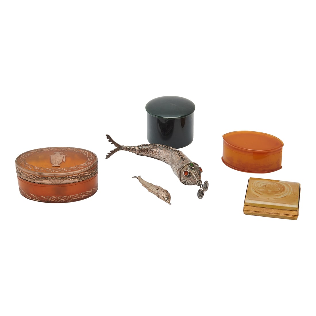 Four Pill or Cosmetic Boxes and Two Silvered Fish: Four Pill or Cosmetic Boxes and Two Silvered Fish, one box of amber like material with silvered metal inlay, a stone topped brass box holding four glass gilt-decorated gaming counters in