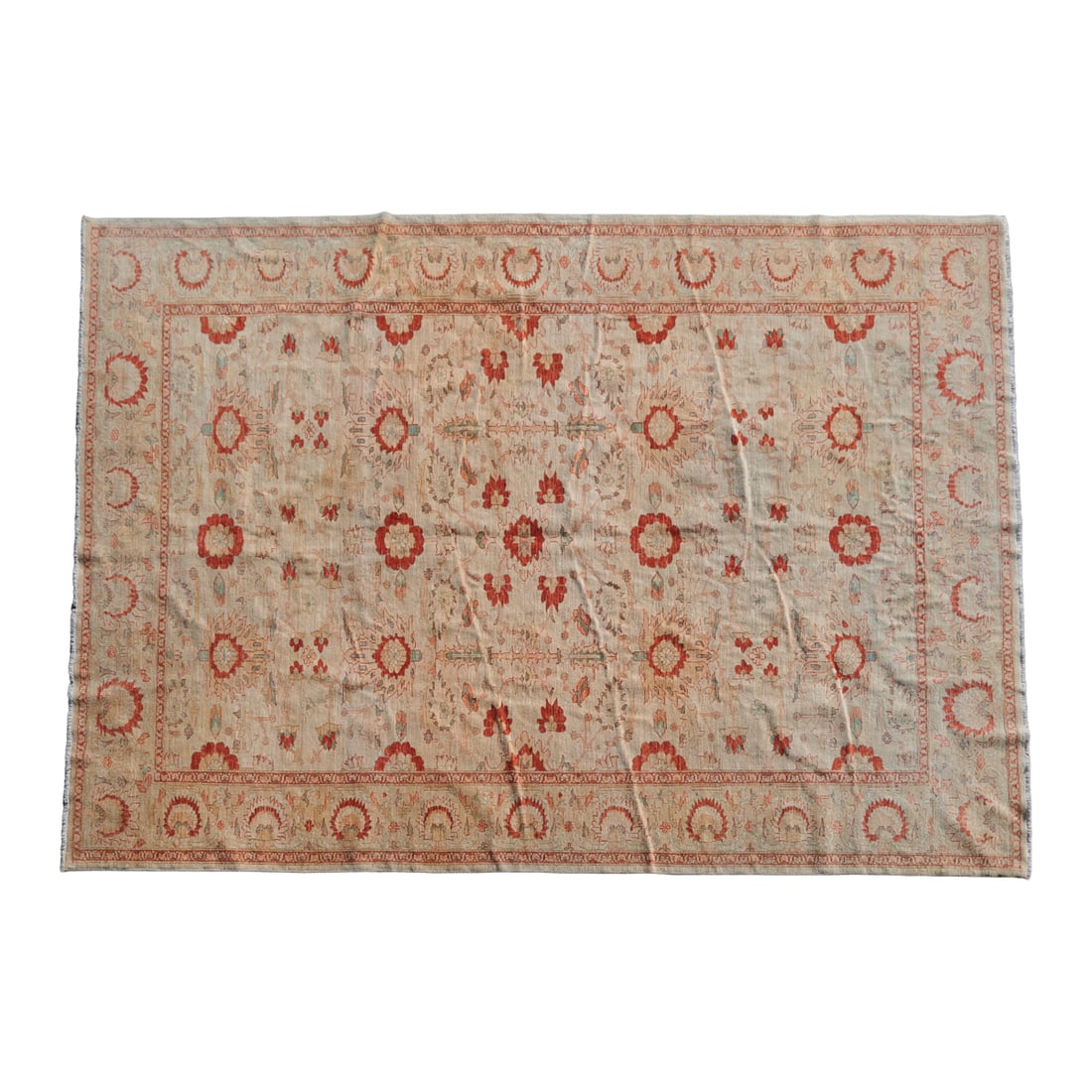 Indo Persian Woven Carpet: Indo Persian Woven Carpet, of wool and cotton, the taupe field with stylized foliate and floral motifs in orange red, pale blue, black, and brown, with slender border and shortened fringe{Approximate