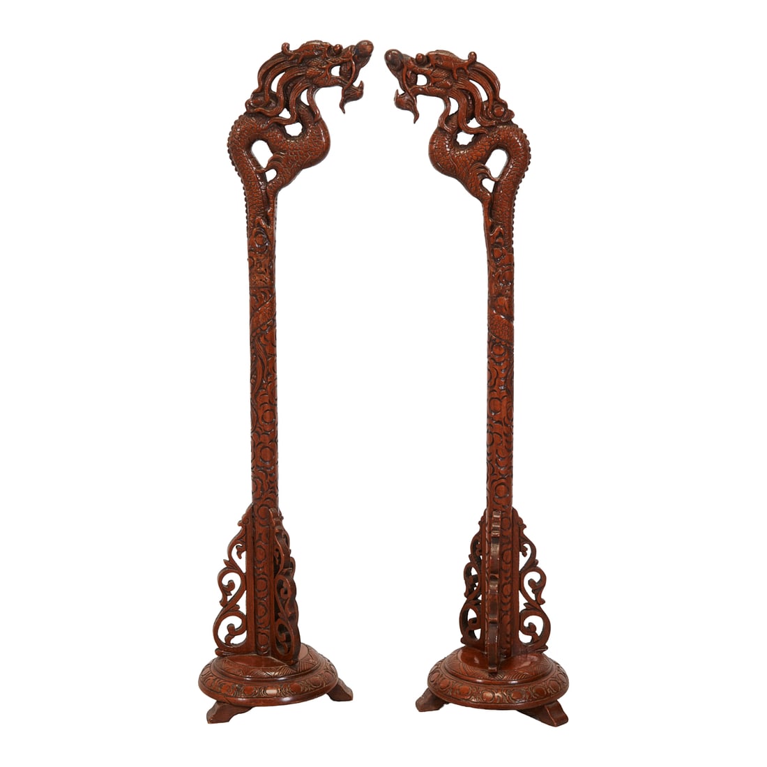 Pair of Chinese Carved Wood Dragon Lantern Holders: Pair of Chinese Carved Wood Dragon Lantern Holders. Each rising from a circular base with scrolling openwork supports to a slender upright shaft carved with foliate and scrolling motifs. The
