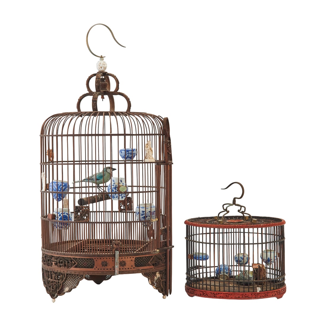 Two Chinese Hanging Birdcages with Porcelain Feeders: Two Chinese Hanging Birdcages with Porcelain Feeders.Two hanging birdcages constructed with vertical wooden bars and circular frames. The larger example with carved wooden base and openwork
