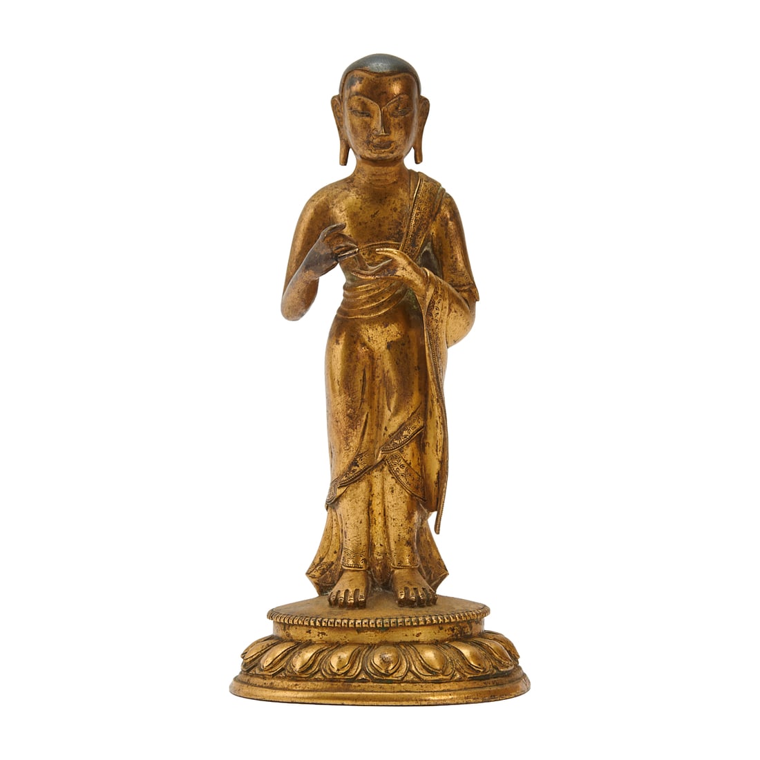 Sino-Tibetan Gilt Bronze Figure of a Buddhist Monk: Sino-Tibetan Gilt Bronze Figure of a Buddhist Monk.Cast as a standing Buddhist monk with elongated earlobes and serene facial expression, the figure shown wearing flowing robes draped over one