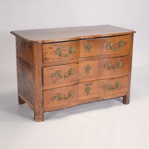 French Provincial Bombe Front Commode: French Provincial Bombe Front Commode. The sinuous shaped top over three long drawers raised on block feet, fitted with rounded rosette handles with fluted drop pulls and cartouche medallion lockplate