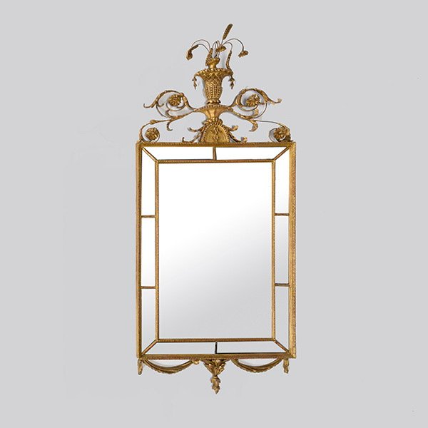 Neoclassical Giltwood and Composition Wall Mirror: Neoclassical Giltwood and Composition Wall Mirror. The rectangular mirrorplate enclosed by a sectional mirrored side panel, surmounted by a flowering urn cresting adorsed by twin scrolling acanthus le