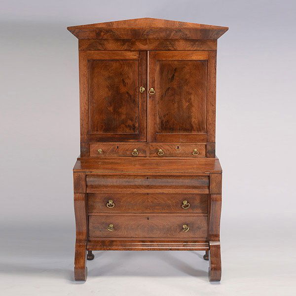 Classical Revival Mahogany Veneer Secretary: Classical Revival Mahogany Veneer Secretary. The outset steeple pediment over twin paneled cupboard doors enclosing a shelved interior, over two side by side drawers, a flip top writing surface, over