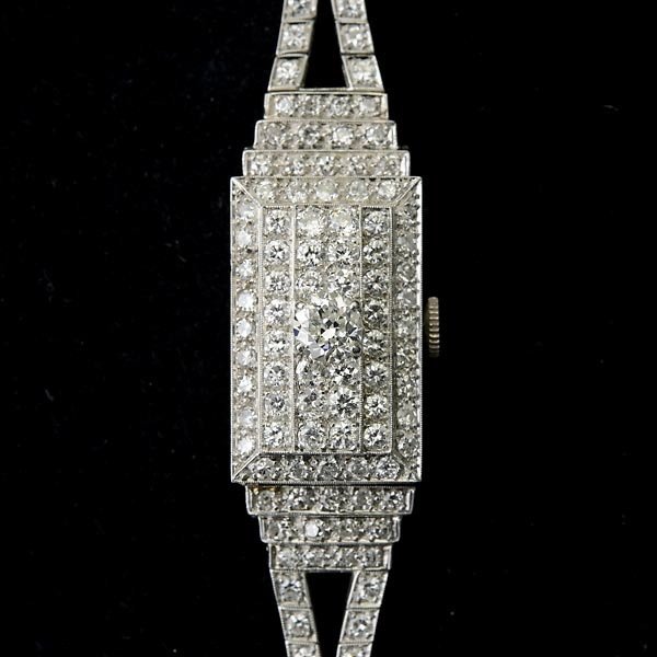 LADIES DIAMOND, PLATINUM, COVERED WRISTWATCH.: LADIES DIAMOND, PLATINUM, COVERED WRISTWATCH. DIAL: Rectangular, silvered, applied silver arrow point and dot hour chapters, baton hands. MOVEMENT: Seventeen jewels, unadjusted, Concord Watch Co. 334F