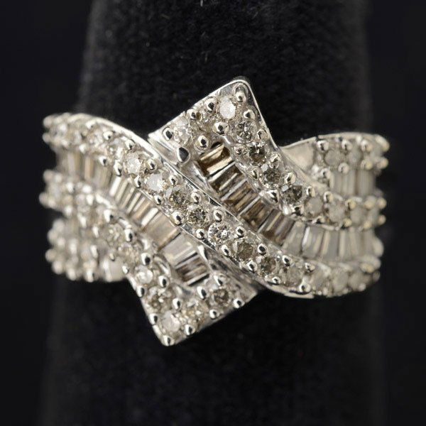 DIAMOND, 10K WHITE GOLD RING.: DIAMOND, 10K WHITE GOLD RING. Featuring forty-five full-cut and thirty baguette-cut diamonds weighing a total of approximately 1.00 cttw., set in a 10k white gold mounting. Size 6, Gross Weight: 2.8 d