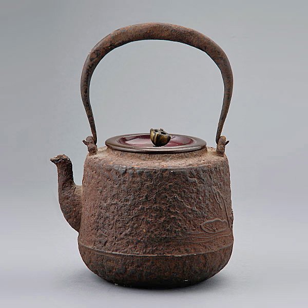 A Japanese Iron Kettle: A Japanese Iron Kettle, with lotus pond motif {Height: 5 1/4 inches (13.3 cm) excluding handle} [Losses, rusting]