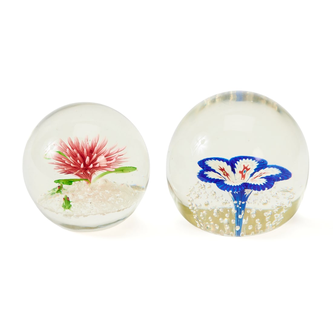 Two Single Specimen Floral Paperweights: Two Single Specimen Floral Paperweights., the first, a stylized flower with six petals in white and blue, with red millifiori, in an air bubble grid surround; the second, a succulent with pink spires
