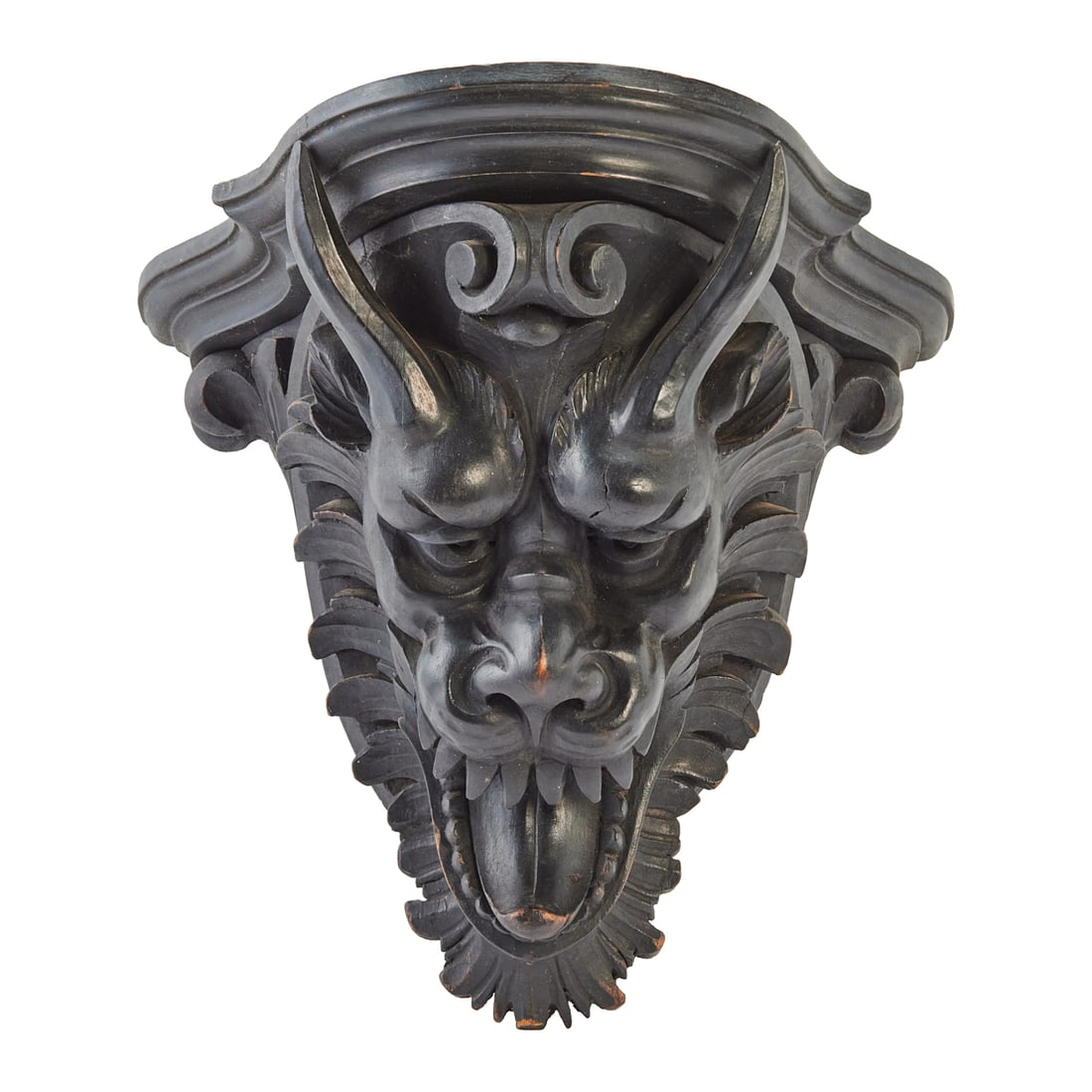 Victorian Style Carved Ebonized Oak Bracket: Victorian Style Carved Ebonized Oak Bracket, the Elizabethan style bracket with stepped plinth above carved dragons head.{Approximate dimensions: 13 5/8" high x 14 7/8" wide x 10 7/8" deep.}.
