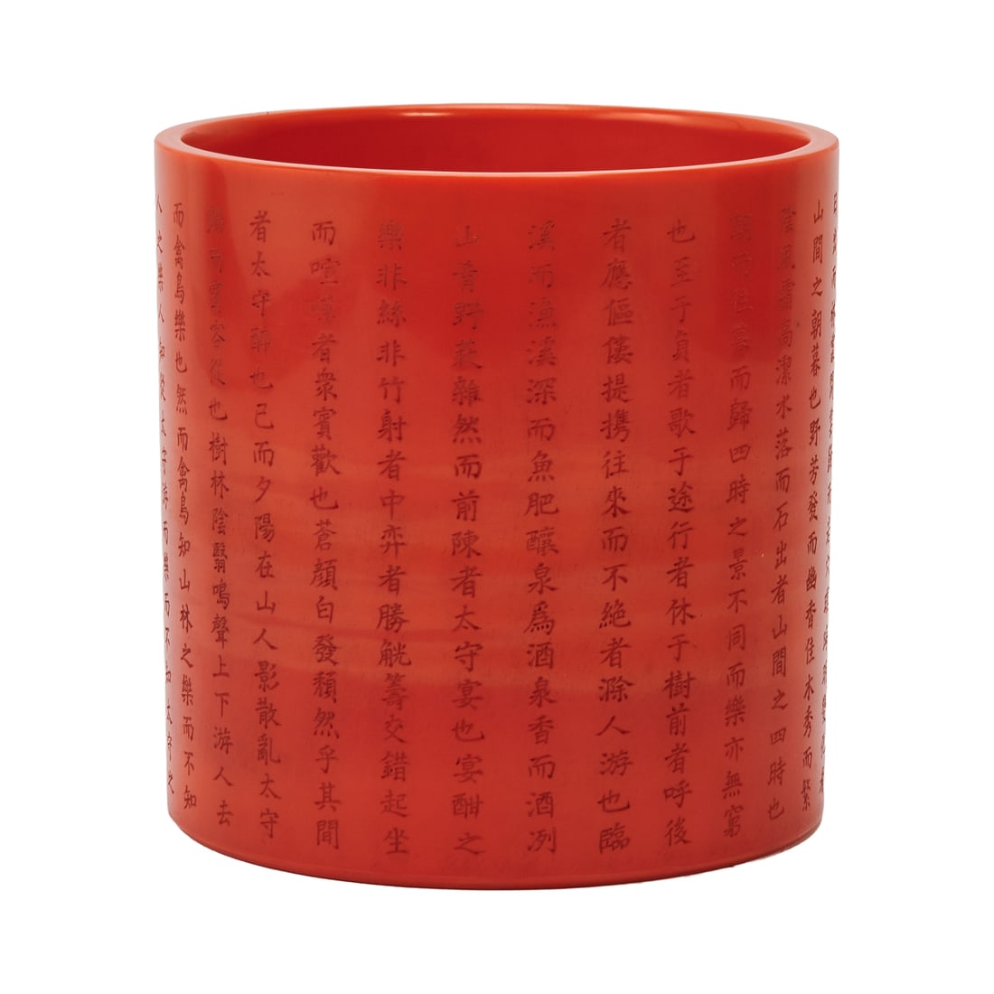 A Chinese Carved Peking Glass Brush Pot: Chinese Carved Peking Glass Brush Pot.The brush pot of cylindrical form, carved from translucent red Peking glass, the exterior finely engraved with a continuous inscription of Ouyang Xiu's Zuiweng Ti