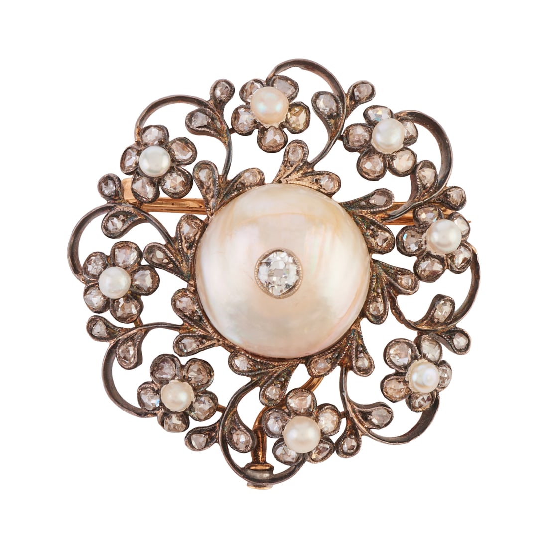 Early Victorian Diamond, Pearl, Silver-Topped, 14k Yellow Gold Brooch: Early Victorian Diamond, Pearl, Silver-Topped, 14k Yellow Gold Brooch. Centering one old mine-cut diamond, set atop a half pearl measuring approximately 14 mm, accented by eight pearls and numerous ro