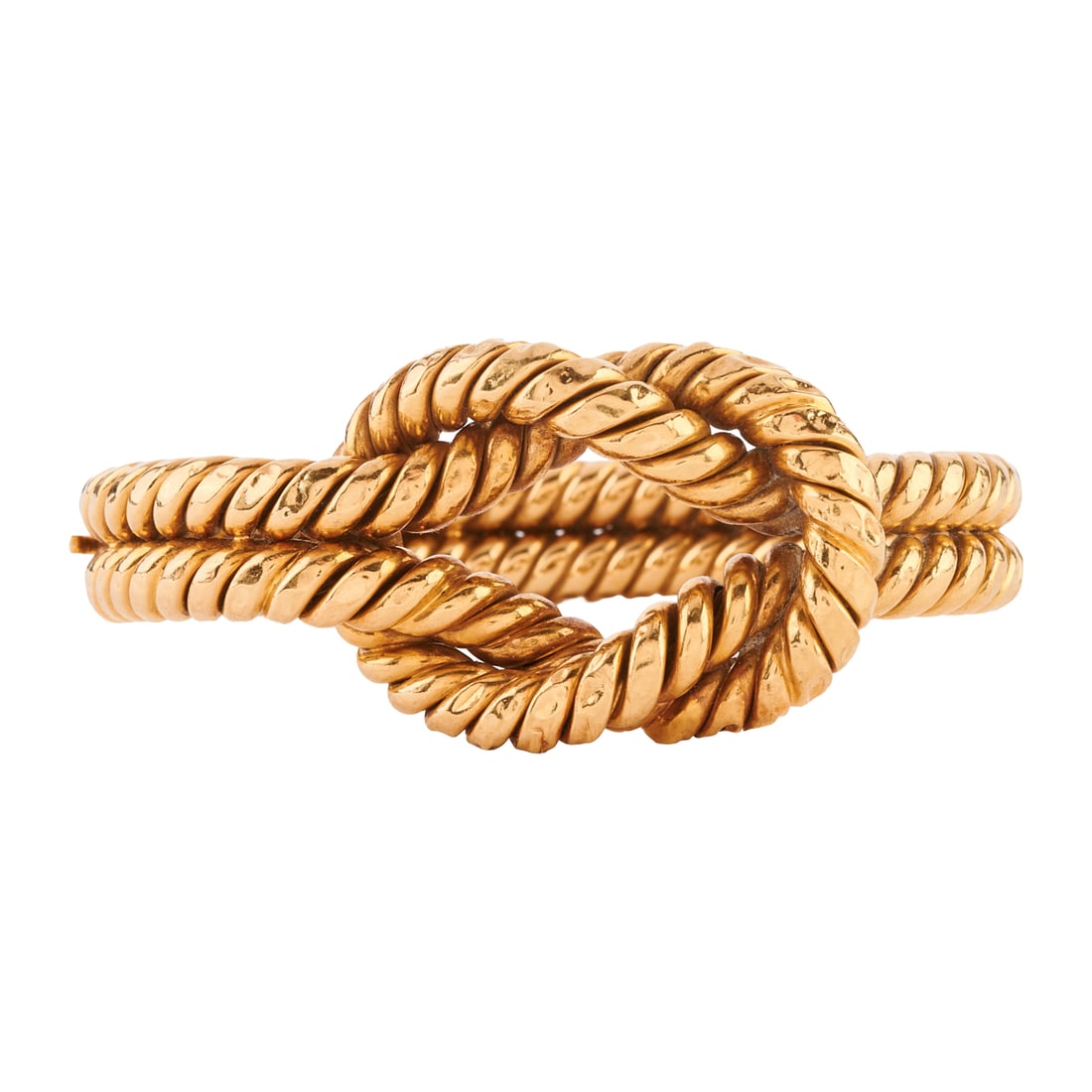 18k Yellow Gold Knot Bracelet: 18k Yellow Gold Knot Bracelet. The 18k yellow gold fluted and knot motif hinged bangle bracelet measuring approximately 30 mm to 12 mm in width, completed by a pressure clasp and with an internal