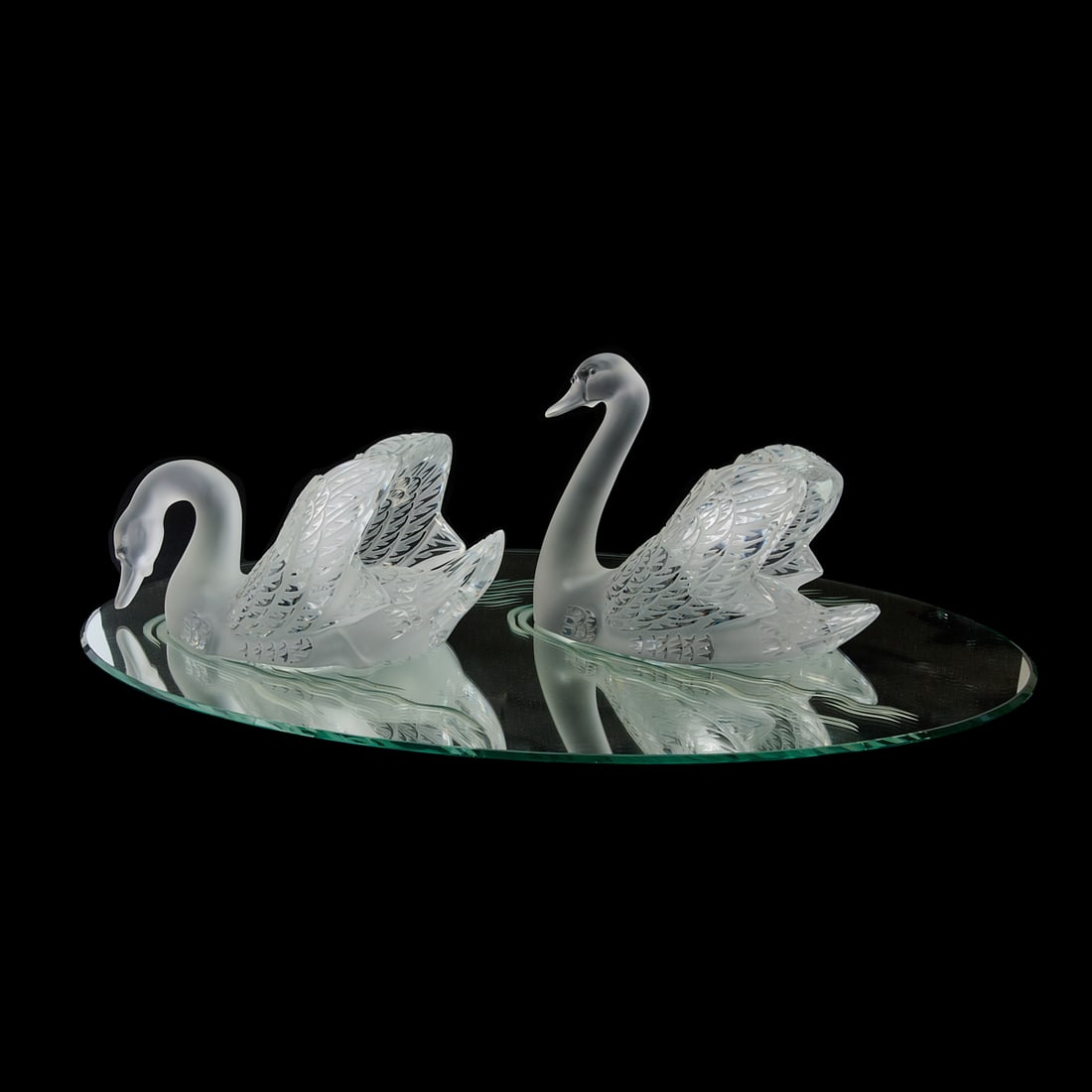 Lalique Crystal Miroir Cygne: Pair of Swans on Oval Mirror: Lalique Crystal Miroir Cygne: Pair of Swans on Oval Mirror, comprising two impressive realistic figures of swans, appearing to float on water, represented by an etched mirror. The swans engraved in