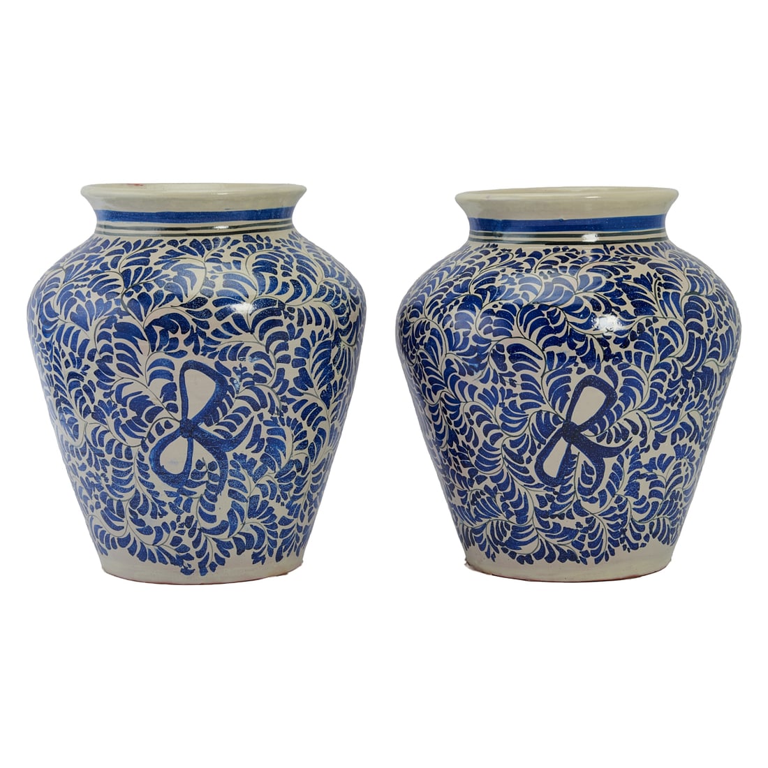 Near Pair of Mexican Talavera Painted Blue and White Pottery Large Vases, one slightly taller and: Near Pair of Mexican Talavera Painted Blue and White Pottery Large Vases, one slightly taller and narrower than the other. The everted necks over high shoulders, tapering toward feet. The bodies