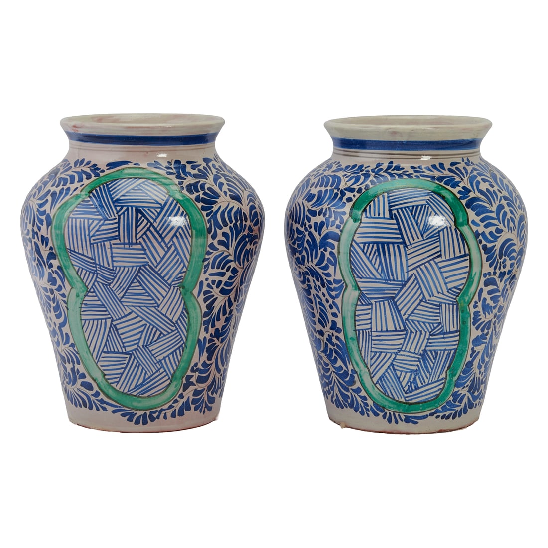 Two Mexican Talavera Pottery Vases, everted mouths, over tapering straight sided bodies, painted in: Two Mexican Talavera Pottery Vases, everted mouths, over tapering straight sided bodies, painted in blue with dense foliate and floral pattern within green cartouches, on the white glazed