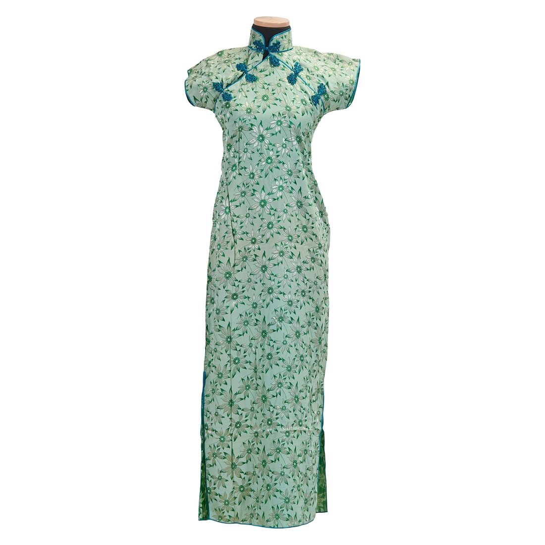 Chinese Green Ground Floral Silk Qipao: Chinese Green Ground Floral Silk QipaoMade in Shanghai, Republic Period, 1932-1934Material: Silk.Approximate Measurements: Shoulders: 16 inches (42 cm), Length (Collar to Hem): 51 1/4 inches (133 cm),