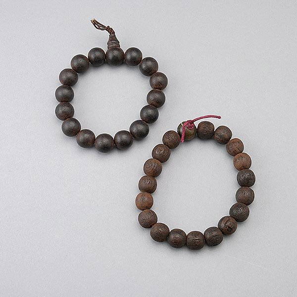 Two Aloeswood Beaded Bracelets: Two Aloeswood Beaded Bracelets, the first with fifteen (15) beads in total; the second with nineteen (19) beads in total {Larger Diameter: 3 1/2 inches (9 cm) approximately} [Wear, cracks]