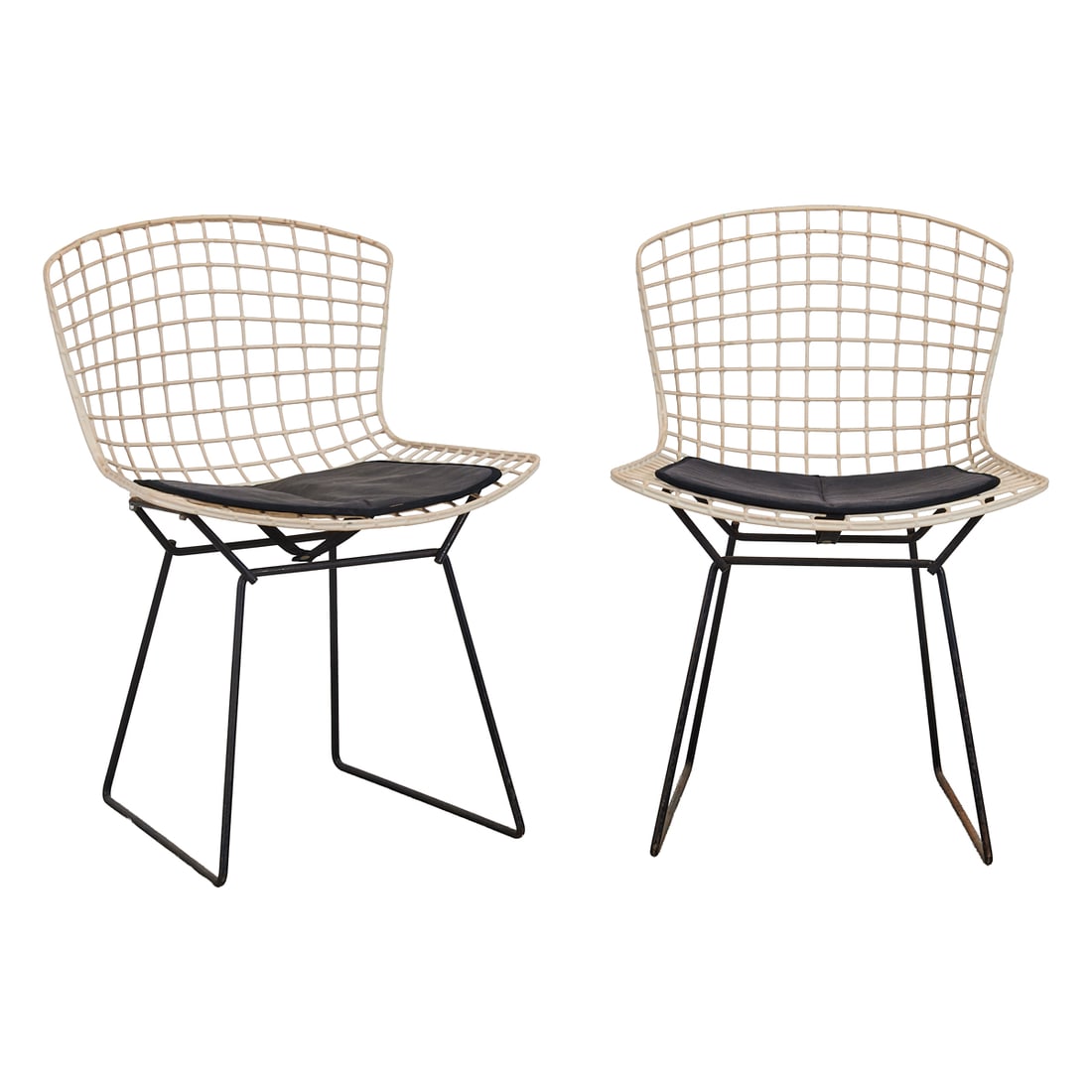Pair of of Harry Bertoia for Knoll Side Chairs, white plastic coated wire backs and seats, over: Pair of of Harry Bertoia for Knoll Side Chairs, white plastic coated wire backs and seats, over black tubular wire frame bases. The original cushions with labels, "H.G. KNOLL PRODUCTS, INC., EAST GREE