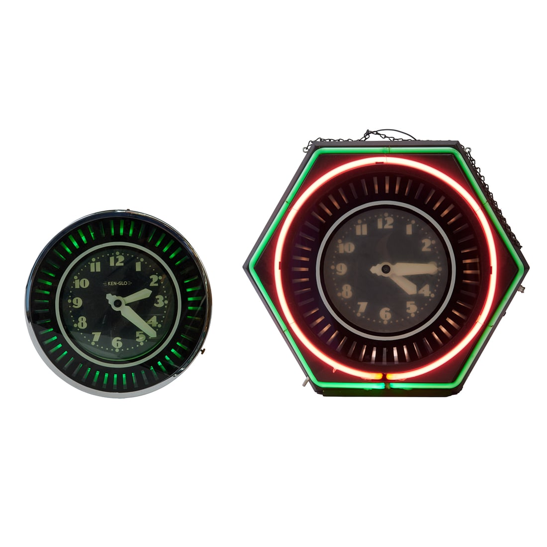 Two 1940s Style Neon Wall Clocks, Ken-Glo and Another. Comprising a clock with octagonal black metal: Two 1940s Style Neon Wall Clocks, Ken-Glo and Another. Comprising a clock with octagonal black metal case and exterior pink and green neon lighting, spinning pinwheel around the black dial with white 