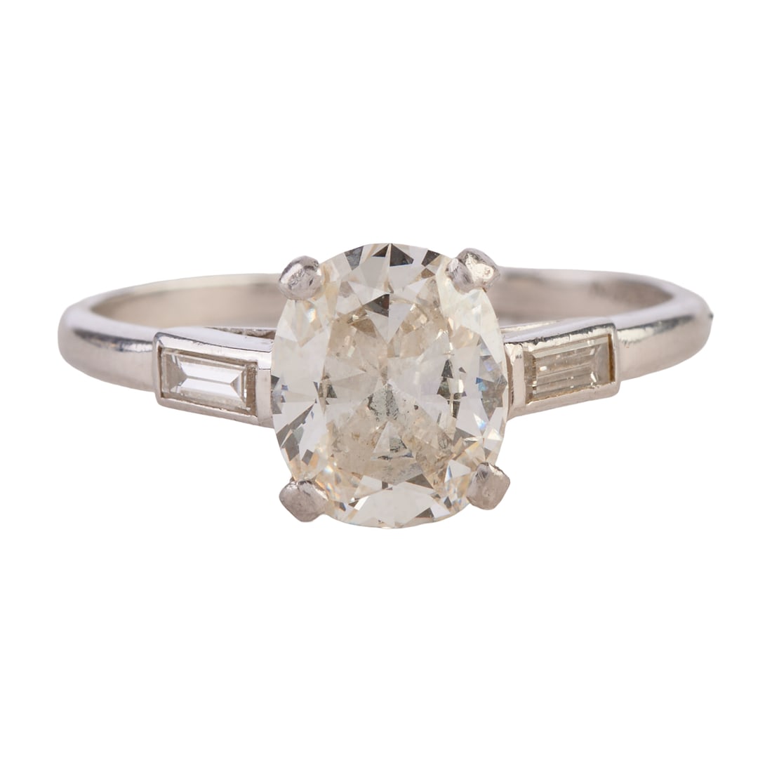 French Monture Boucheron Diamond, Platinum Ring. Featuring one oval-cut diamond weighing: French Monture Boucheron Diamond, Platinum Ring. Featuring one oval-cut diamond weighing approximately 0.92 ct., flanked by two baguette-cut diamonds weighing a total of approximately 0.07 cttw., set 