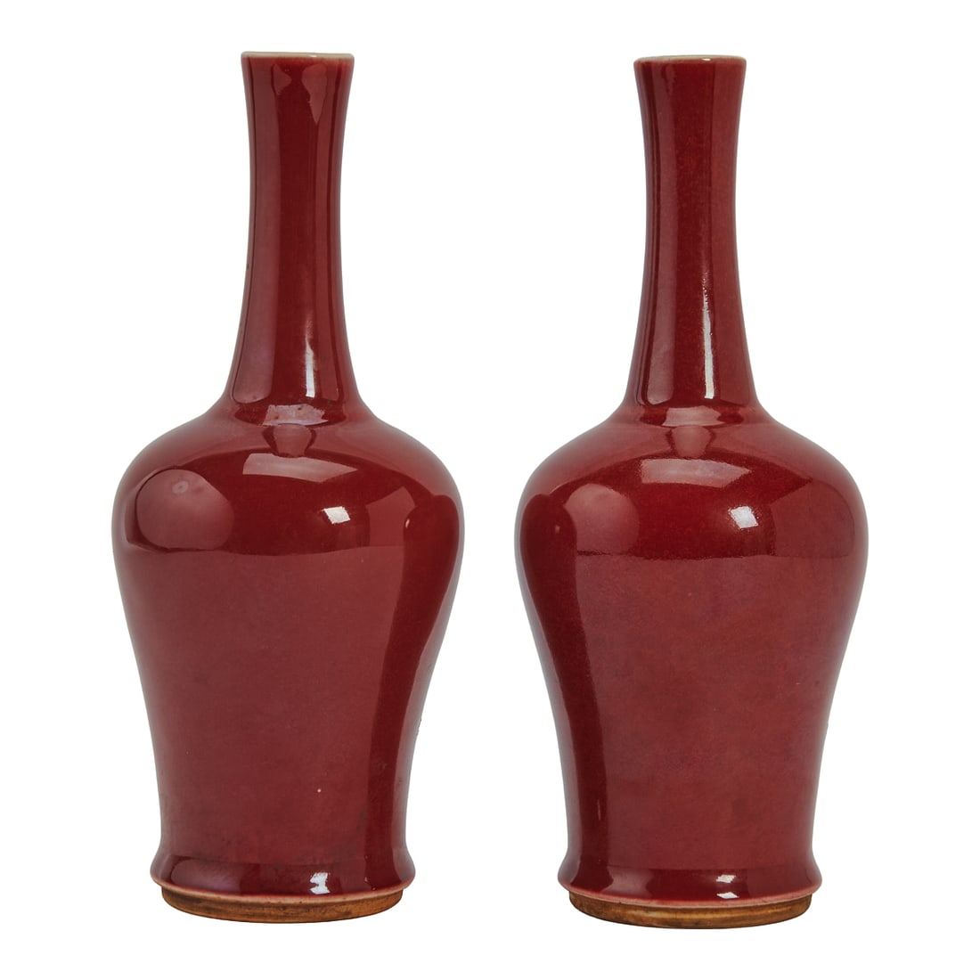 Pair of Chinese Porcelain Oxblood Vases. Of baluster body with a tall, slightly tapered neck,: Pair of Chinese Porcelain Oxblood Vases. Of baluster body with a tall, slightly tapered neck, covered overall with oxblood red color, the interior and bottom remain ivory white, incised a double circl