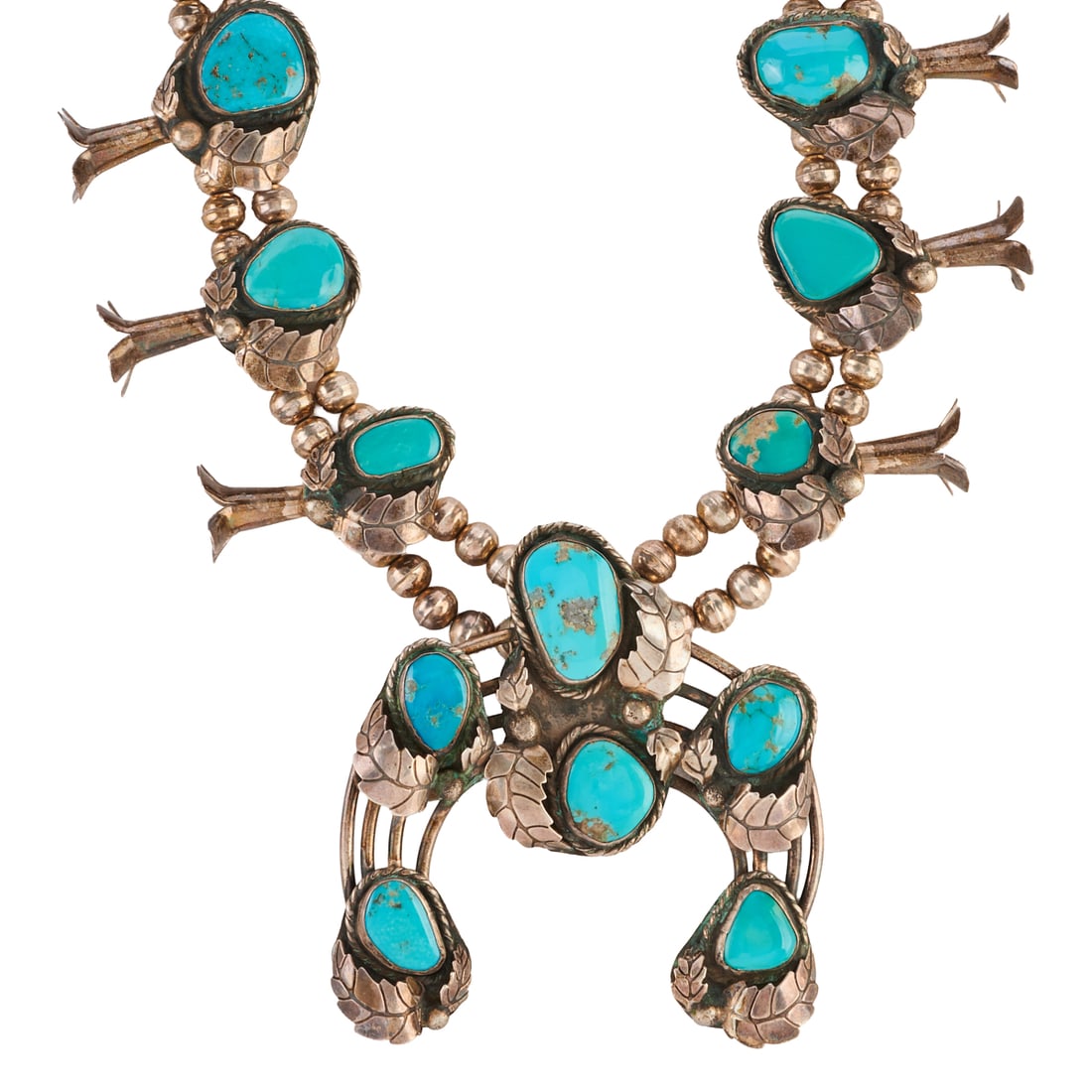 Native American Turquoise, Silver Squash Blossom Necklace: Native American Turquoise, Silver Squash Blossom Necklace. Centering one varying shaped turquoise cabochon, silver naja measuring approximately 95 x 85 mm, accented by ten varying shaped turquoise