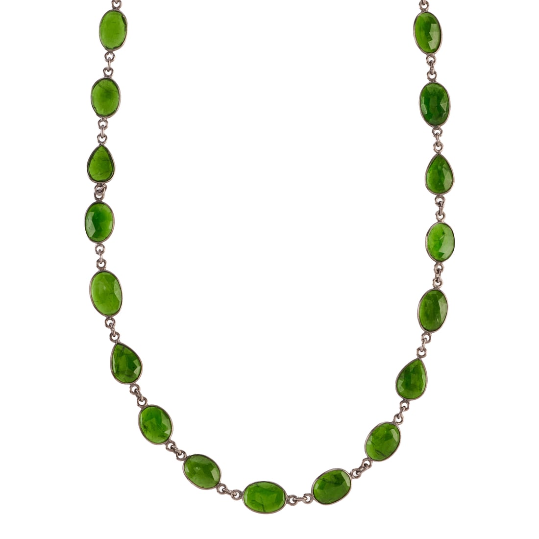 Diopside, Oxidized Silver Necklace: Diopside, Oxidized Silver Necklace. Featuring numerous oval and pear shaped, faceted diopsides, bezel set and linked by oxidized silver mountings, completed by a lobster claw clasp, forming a 34 inch 