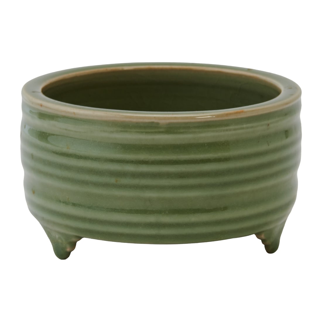 A Qing Dynasty Longquan Celadon Tripod Censer: The cylindrical censer is sturdily potted with a broad, rounded rim, straight sides, and three short shaped feet. The exterior is encircled by a series of evenly spaced horizontal ribs, creating alter