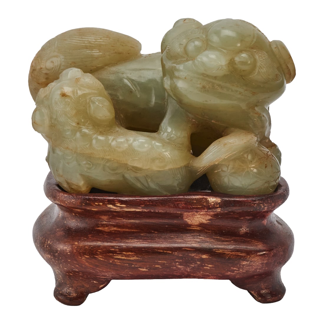 A Chinese Carved Hetian Jade Taishi Shaoshi: A Chinese Late Ming-early Qing Dynasty Carved Hetian Jade Taishi Shaoshi. The Hetian jade is carved in the round as a recumbent Buddhist lion accompanied by its cub, the two playfully intertwined with