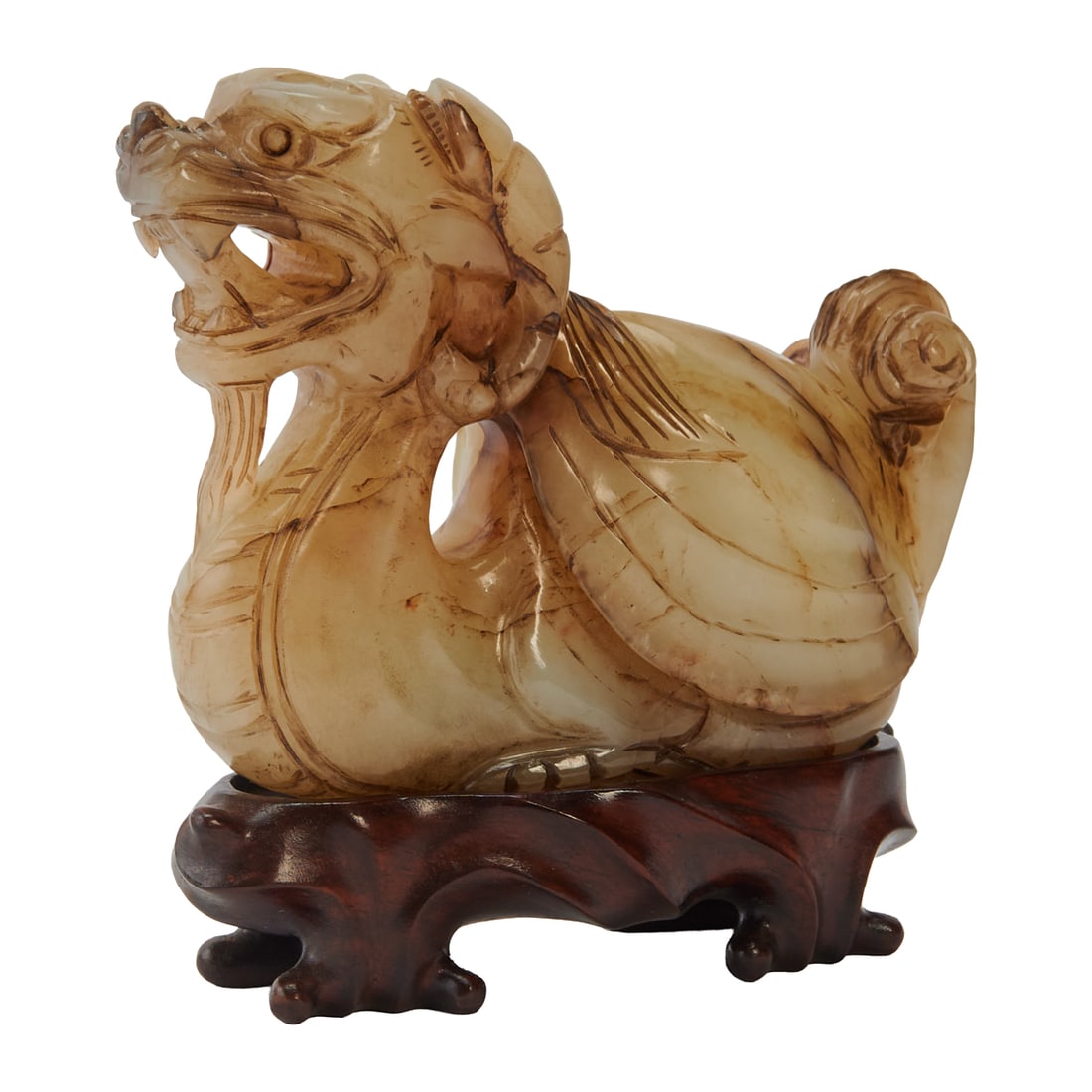 A Chinese Carved Xiu Jade Figure of A Bixie: A Chinese carved pale green Xiu jade figure of a bixie.The pale green Xiu jade finely carved as a recumbent bixie, the mythical beast depicted with its head raised and mouth open, revealing prominent 