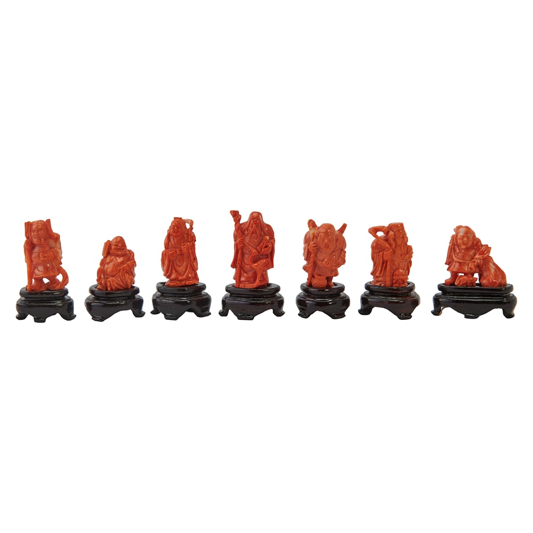 Seven Japanese Carved Lucky Gods Coral Figures: A Group of Seven Japanese Carved Coral Figures. Each finely carved as one of the Seven Lucky Gods (Shichifukujin), comprising Ebisu, Daikoku, Bishamonten, Benzaiten, Fukurokuju, Jur?jin, and Hotei. {L