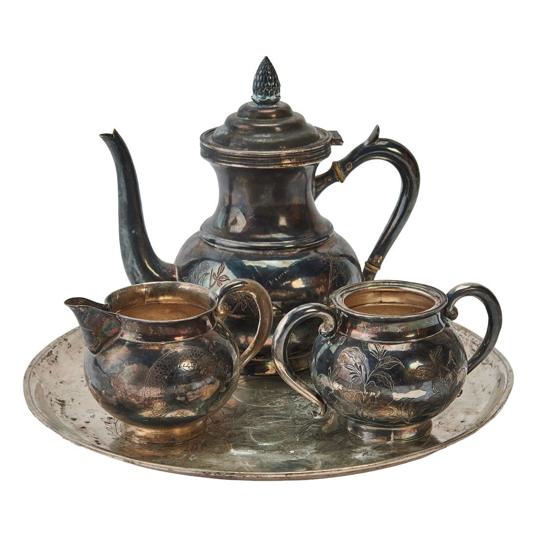 Chinese Silver and Sterling Tea Set: Chinese Silver and Sterling Tea Set.; Comprising teapot with hinged lid and pinecone knop, cream jug,;two handled sugar bowl, and serving tray, all etched with a dragon chasing a mythical pearl, the