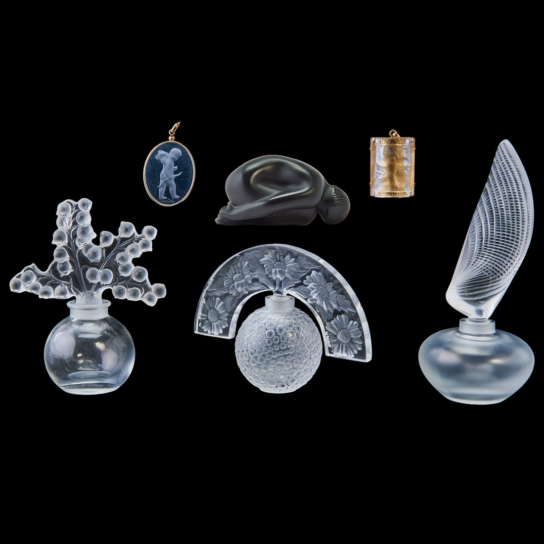 Six Lalique Crystal Articles Including Three Perfume Bottles: Six Lalique Crystal Articles Including Three;Perfume Bottles, a Figure, and Two Pendants.; Includes original boxes.;{Approximate dimensions:; Tallest bottle 6 3/16" high with stopper, pendant 1 5/8"