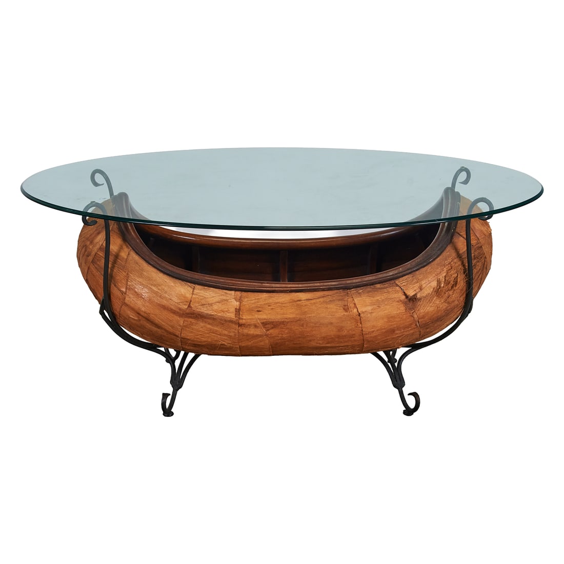 Glass Top Low Table with Rustic Model Canoe Cradled in Iron Base: Glass Top Low Table with Rustic Model Canoe Cradled in Iron Base. The canoe made of pieced wood panels.;{Approximate dimensions:; 22 1/4" high x 52" wide;x 32" deep.}.;